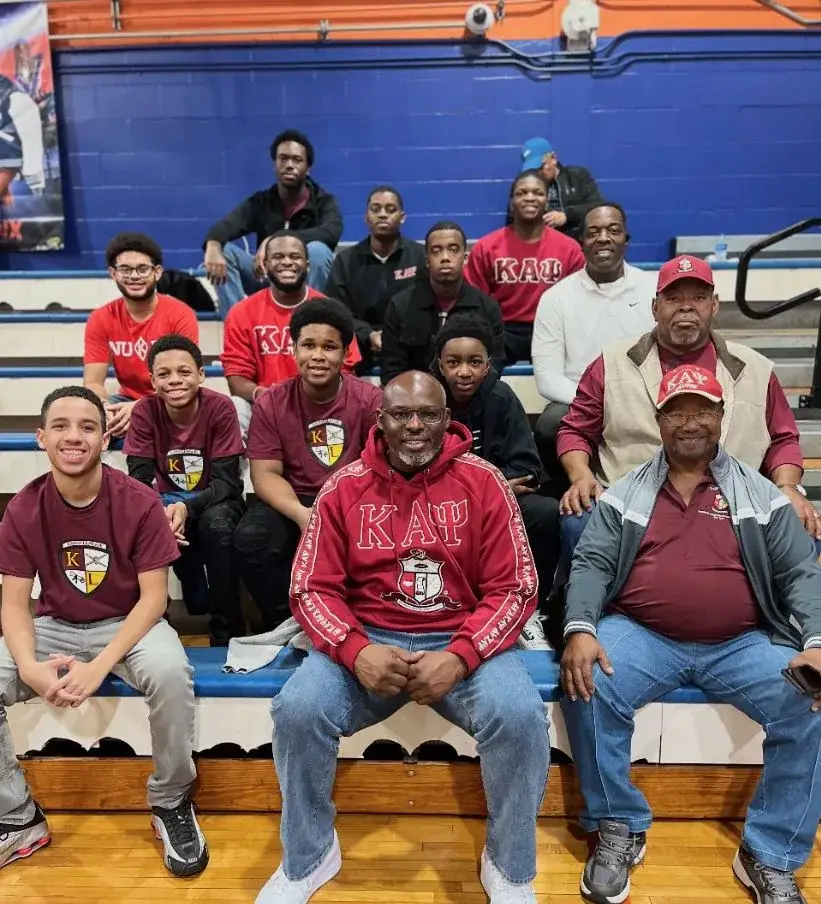 Gainesville Alumni brothers with Kappa League young men at a basketball game